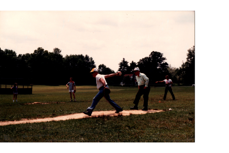 A man throws a softball