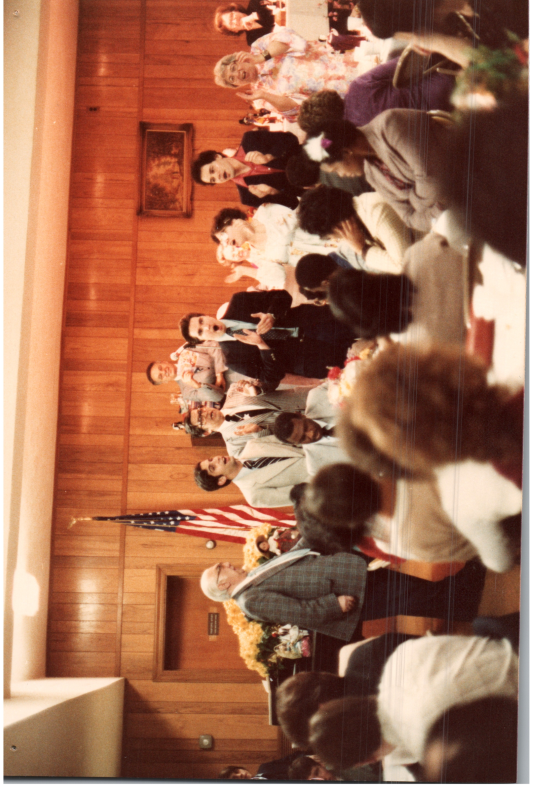 A group sings with the Bogdans in the background