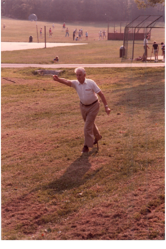 A man tosses a horseshoe