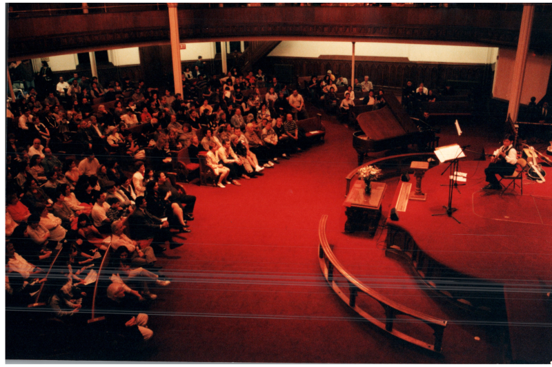 Music performance in front of an Albanian flag in the sanctuary