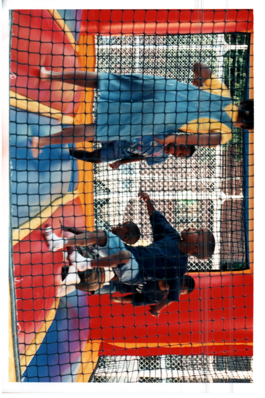 Children play in a bouncy house