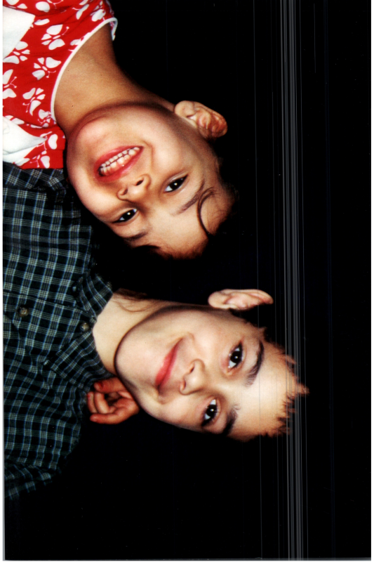 A boy and girl smile for a portrait