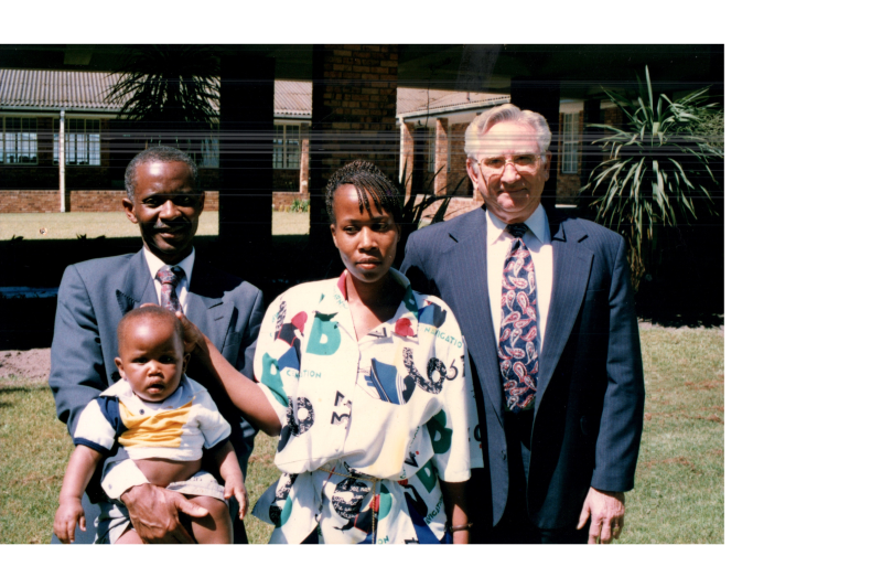 Two men and a woman stand with a baby