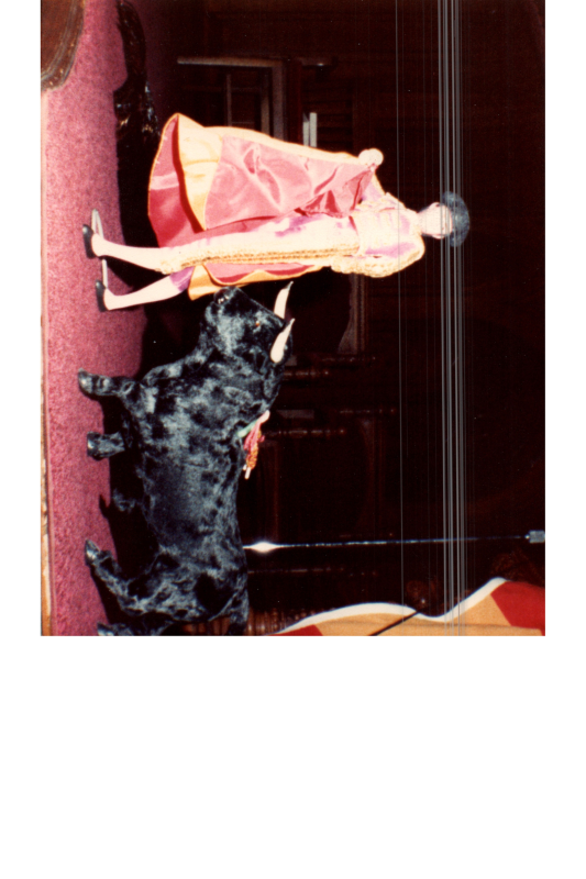 A Spanish doll figurine with a stuffed bull and a Spanish flag