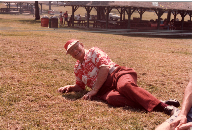 A man lies down on a field