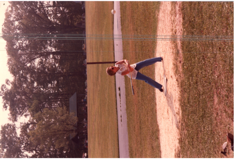 A woman swings a baseball bat