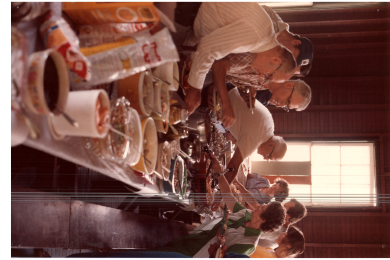 Congregants grab food from a spread