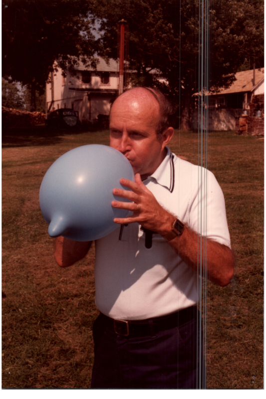 A man inflates a balloon