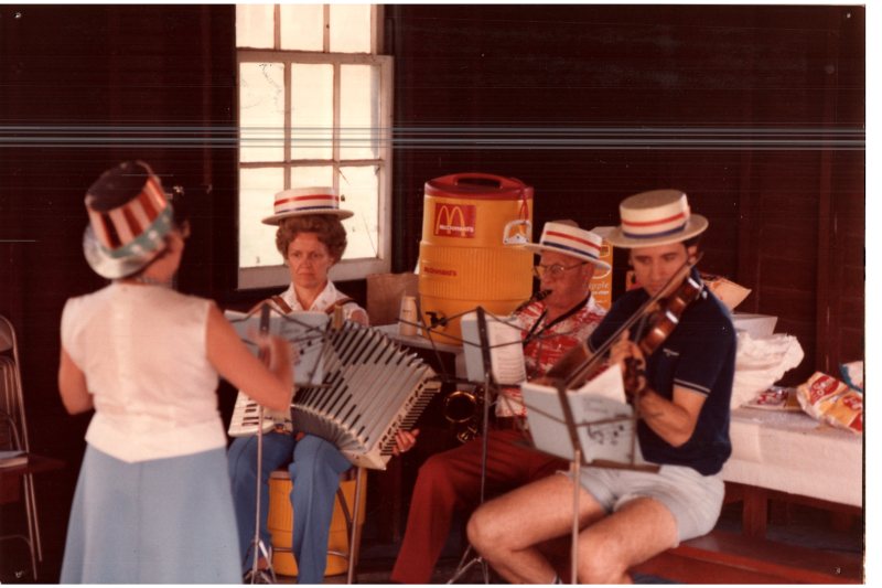 People dressed in American clothing play instruments together