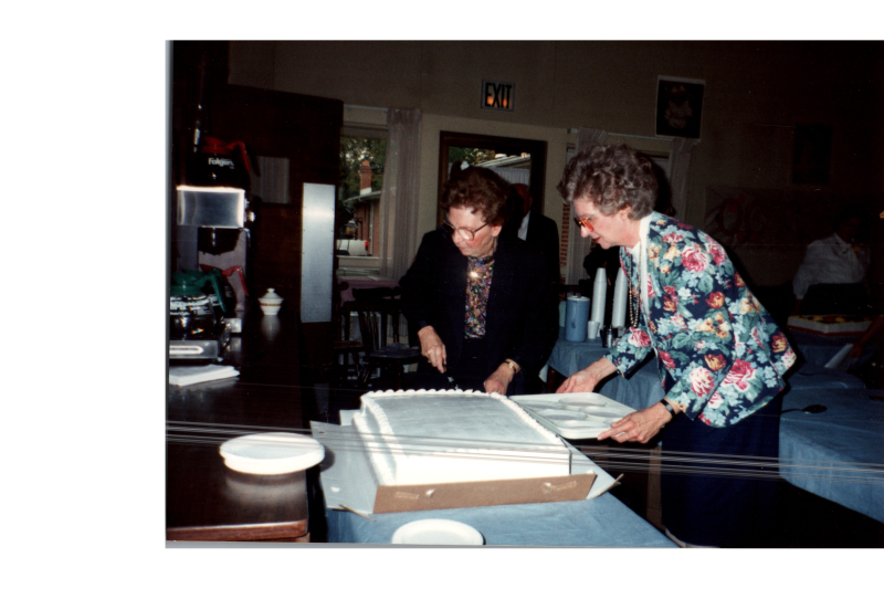 Betty Roberson and another woman set out a cake