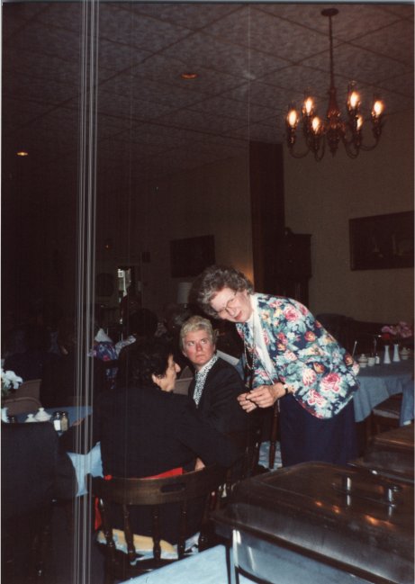 Betty Roberson speaks with two women