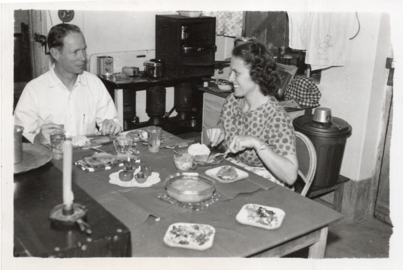 A picture from the Olsons captioned, "Calvin and Marian eating Christmas dinner in their home in Gopalganj, 1961"