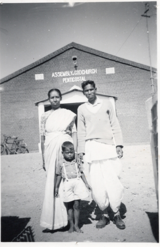 Portrait of the Khachaps mentioned in the Modders' letter standing in front of a church with text reading, "Assembly of God Church, Pentecostal"