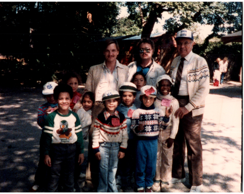 A group smiles with Pastor Bogdan at the zoo