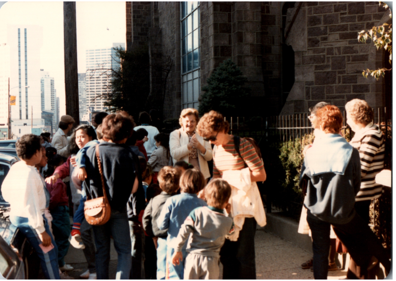 A group gathers outside of the building