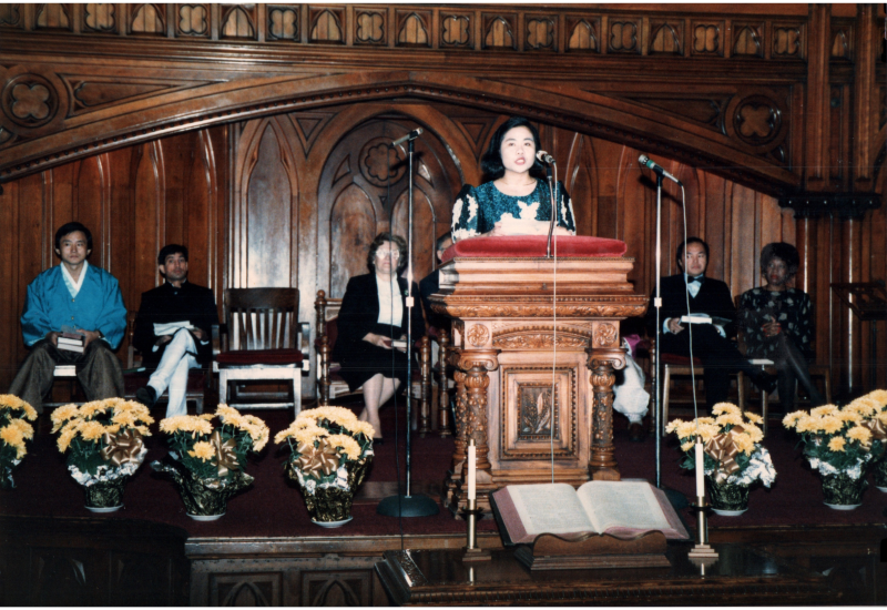 A woman speaks into a microphone