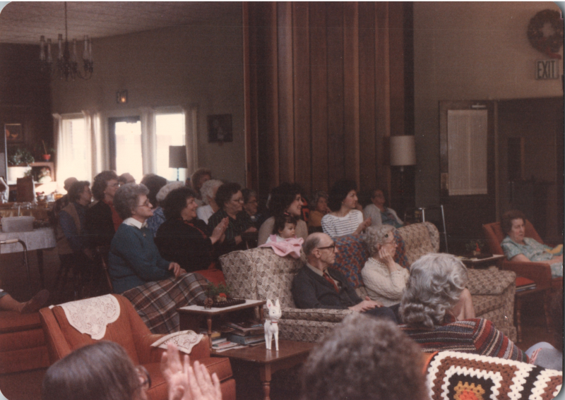 A group of older women sit together