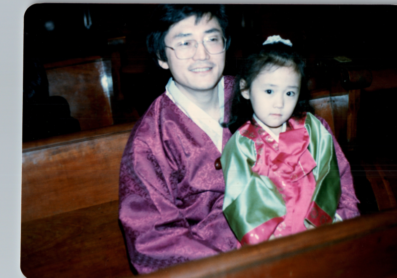 A man smiles with a young girl