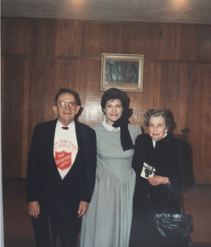 A woman in costume poses with a man in a Salvation Army t-shirt and an older woman