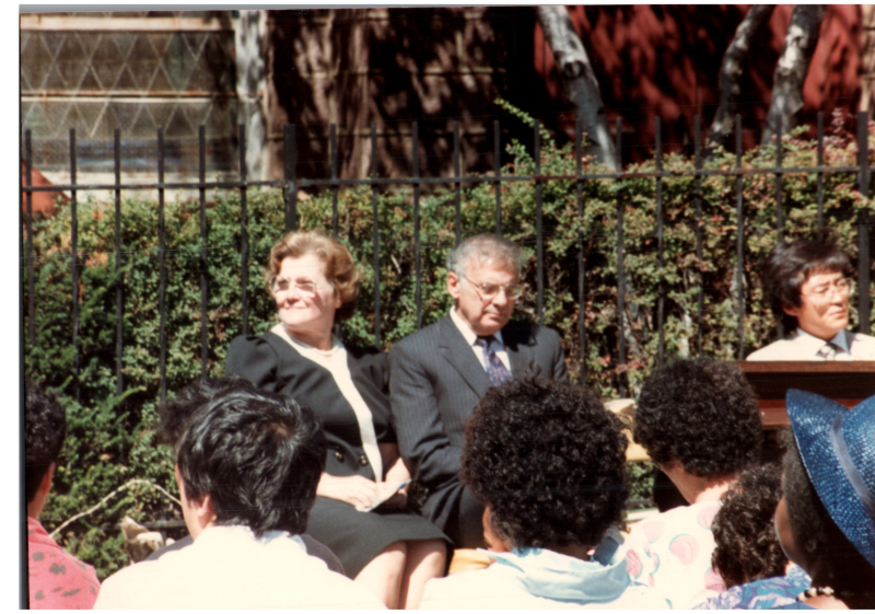 Rev. and Mrs. Bogdan sit during an outdoor service