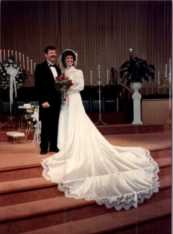 Wedding picture of Jill Briscoe of Chi Alpha. A message on the back reads, "Greetings from Mr. and Mrs. Briscoe! Our wedding went off perfectly and everything was beautiful- of course! :) There was some apprehension with the Persian Gulf crisis, but the Lord intervened on our half! PTL! (It's a long story! Some day I must write a book!)
