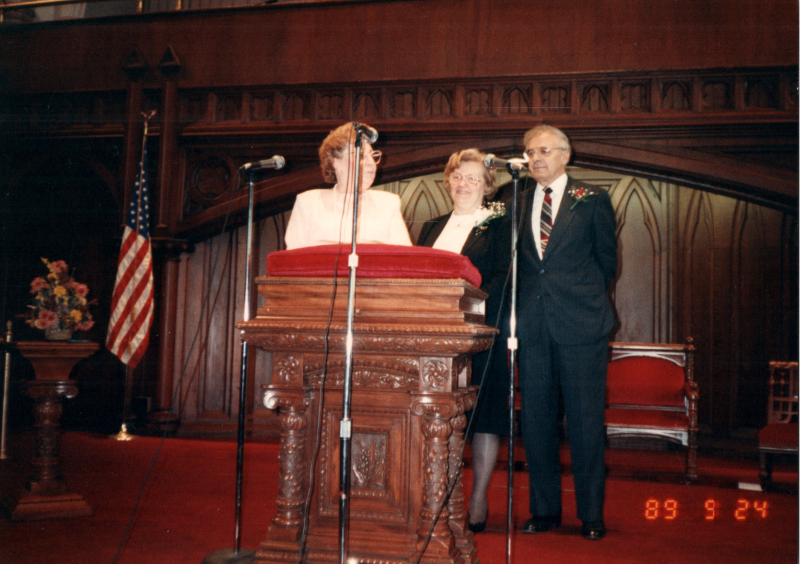 Image of the Bogdans on stage with a woman and the caption, "To Pastor Bogdan and Wife With love From familyy Revorido da Silva"