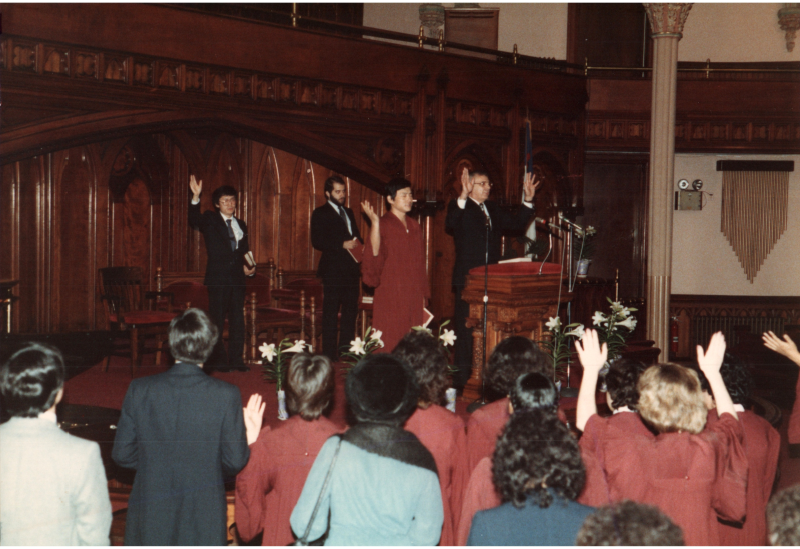 Congregants pray together before beginning baptisms