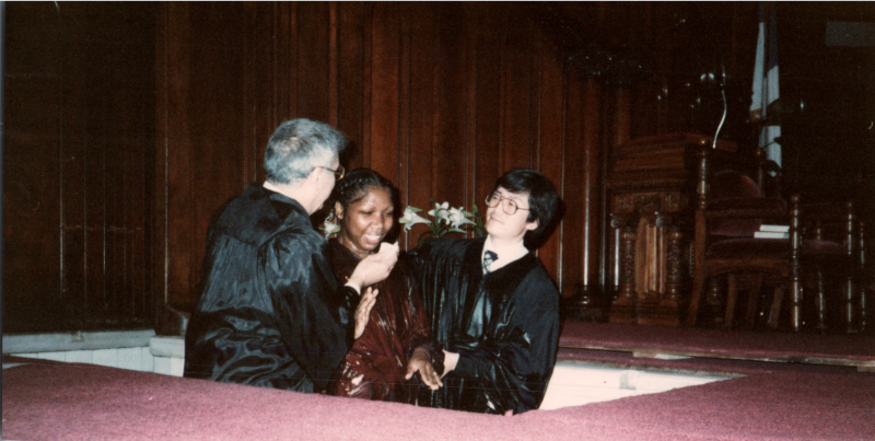A woman is baptized