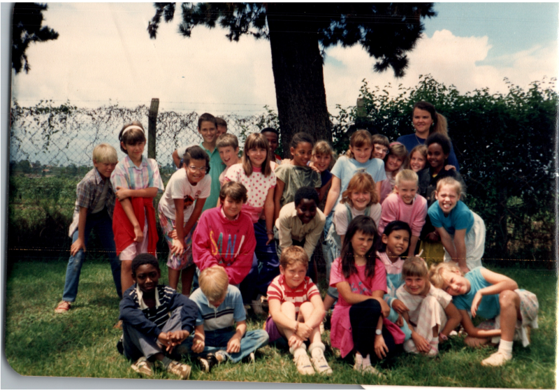 A group of children smile together