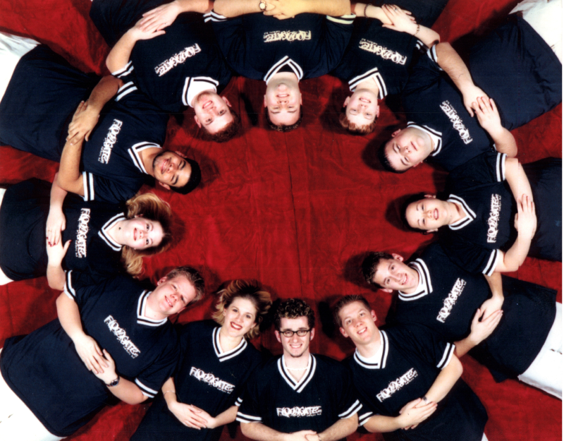 A group in matching uniforms smiles together