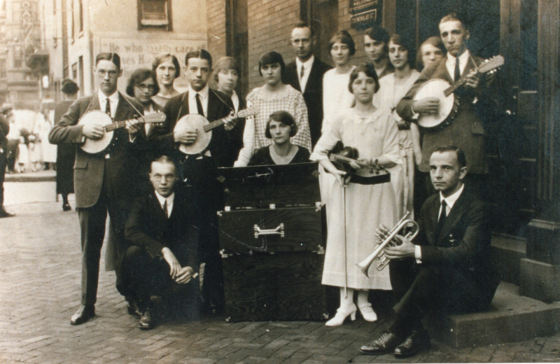 Musicians pose together with their instruments