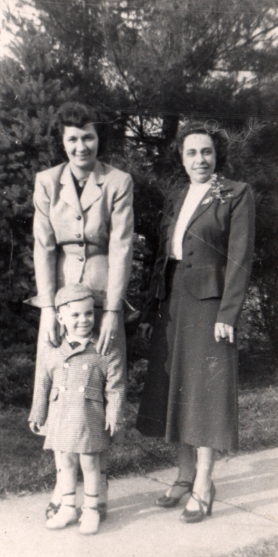 Two women and a young boy smile together
