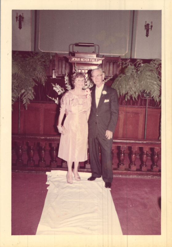 A man and woman smile together in the sanctuary at 19th and Green Streets