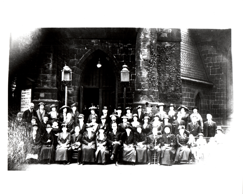 Members of Fifth Baptist Church sit in front of the church exterior at 18th and Spring Garden