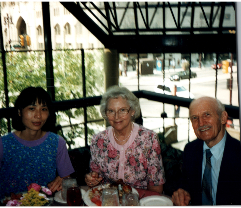 A man and two women dine together