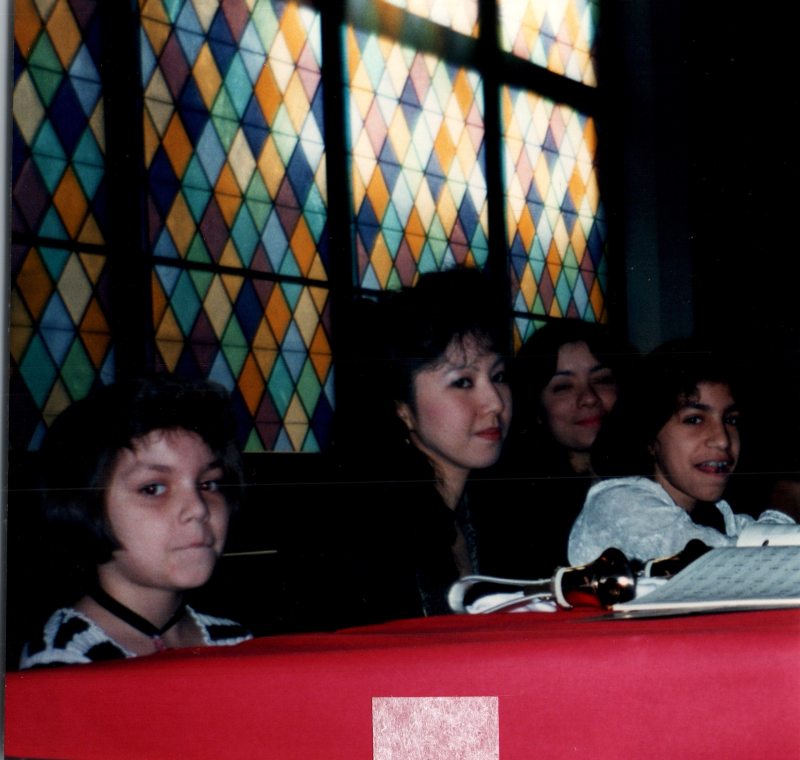 Members of the bell choir, including Ginny Vega, smile for a picture