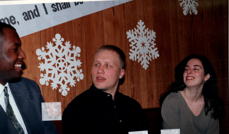 Two men, including Mike Wulin, speak with a woman