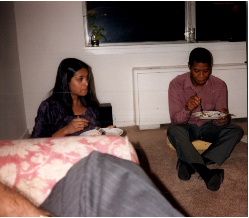 A woman and Edward Fortenberry eat on the floor