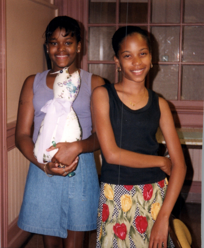 Two girls smile with a craft