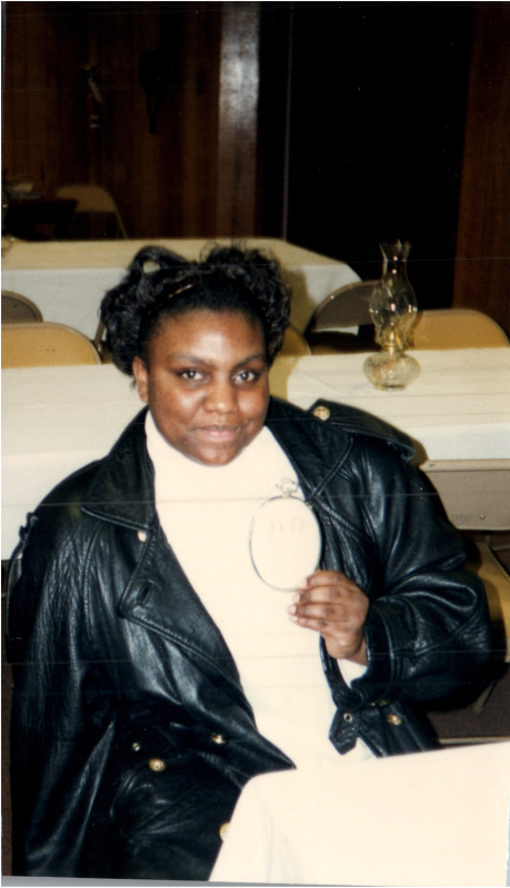 A woman holds up a craft