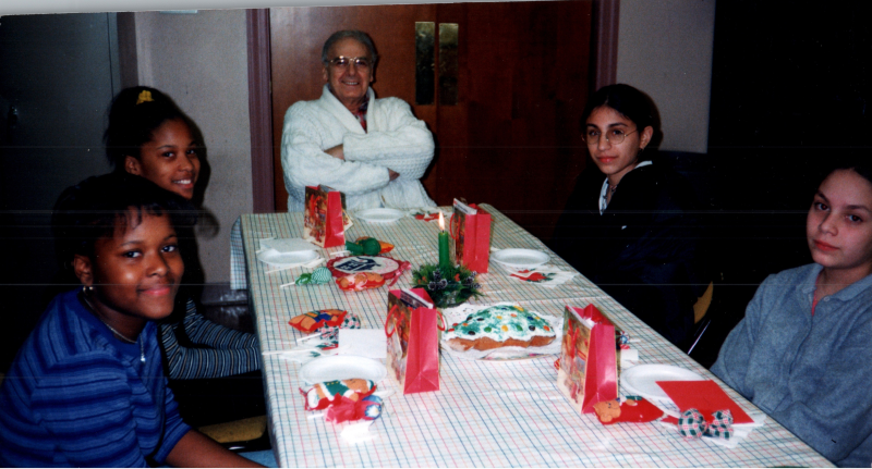 A group of girls sit around a table with Pastor Bogdan