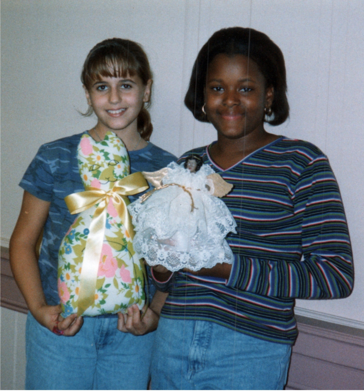 Two girls smile with a craft